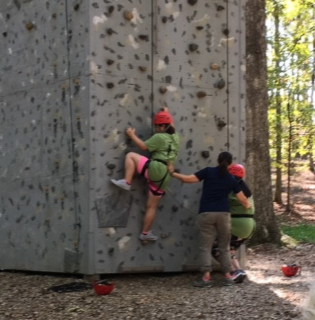 FSPS migrant students climb a rock wall at the Arkansas Migrant Education Student Leadership Academy (AMESLA).