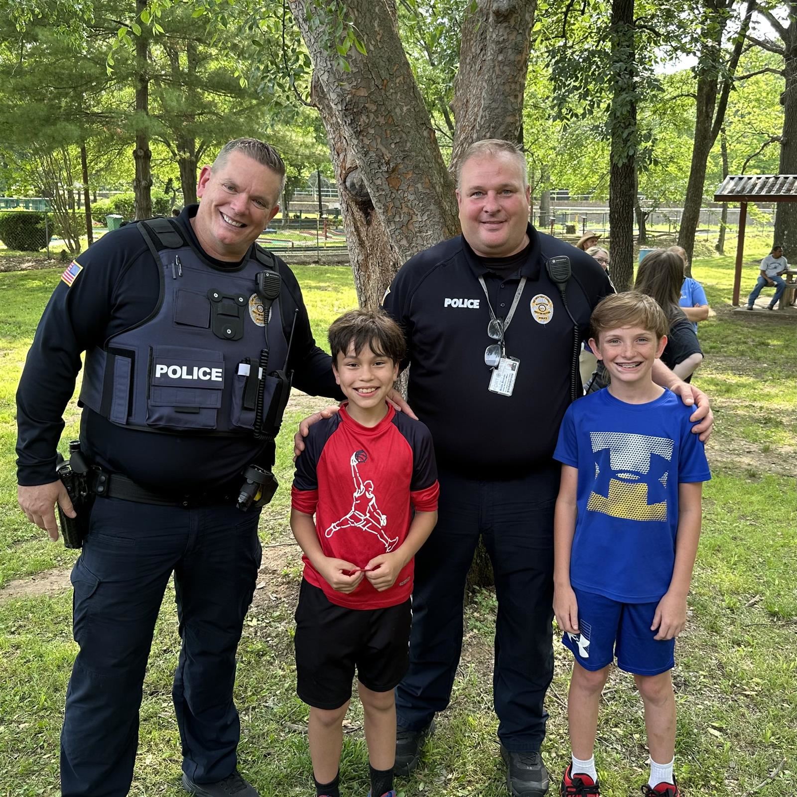 Two Fort Smith Public School Police Officers with two safety patrol students