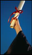 Image of a hand holding a diploma. 