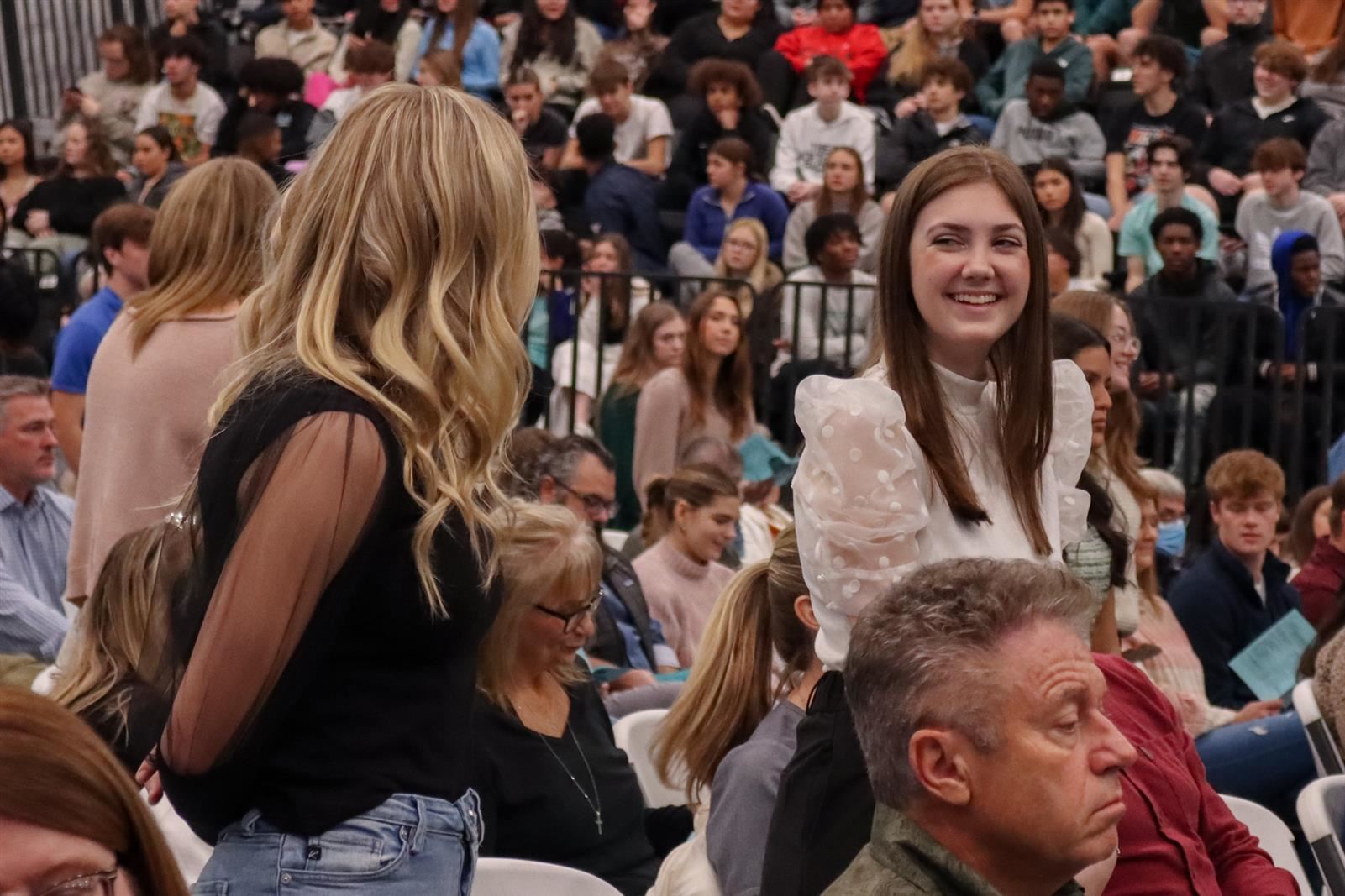 Two students smiling at each other